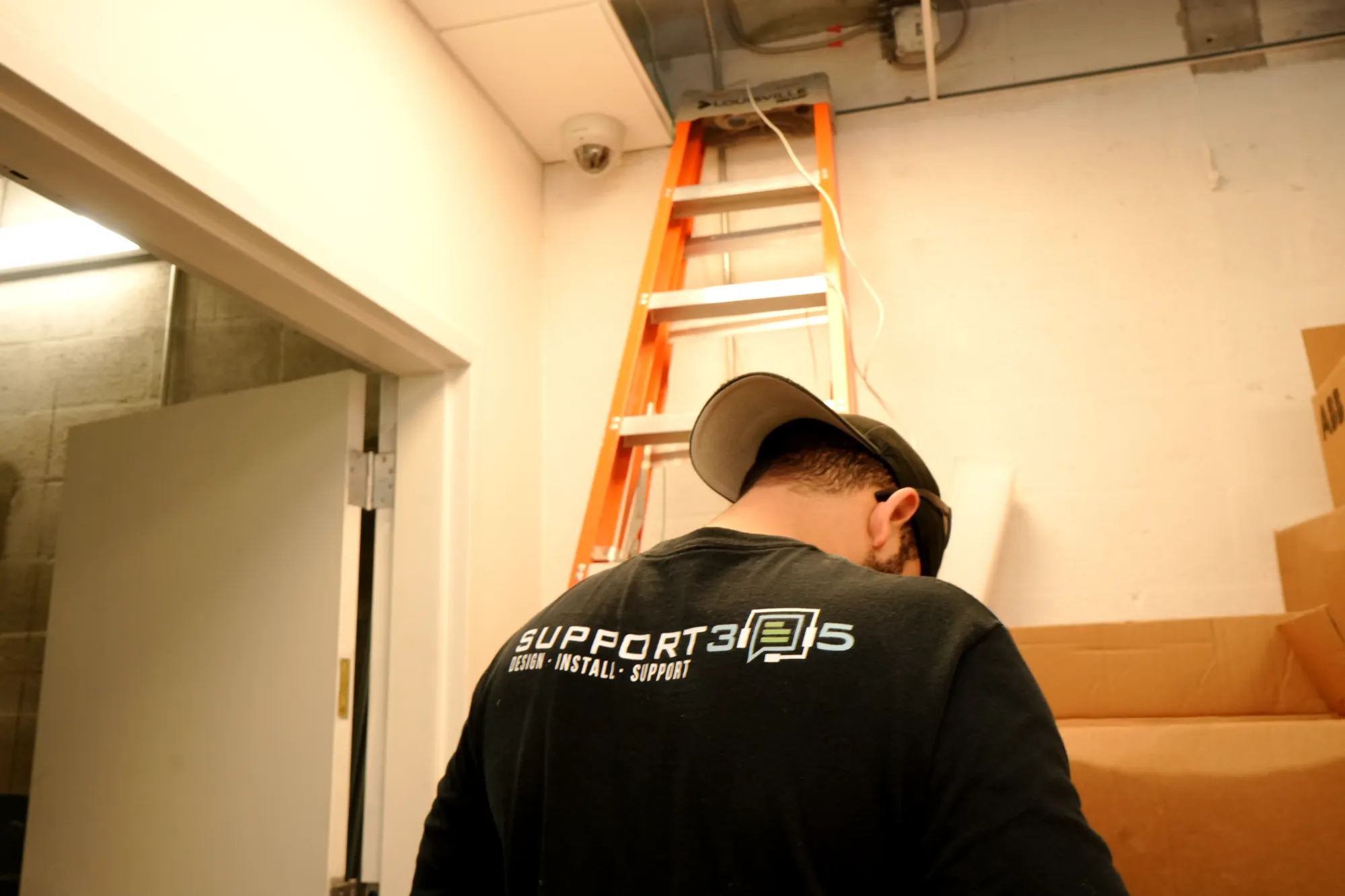 Dome camera installed above a corridor by a DIST technician