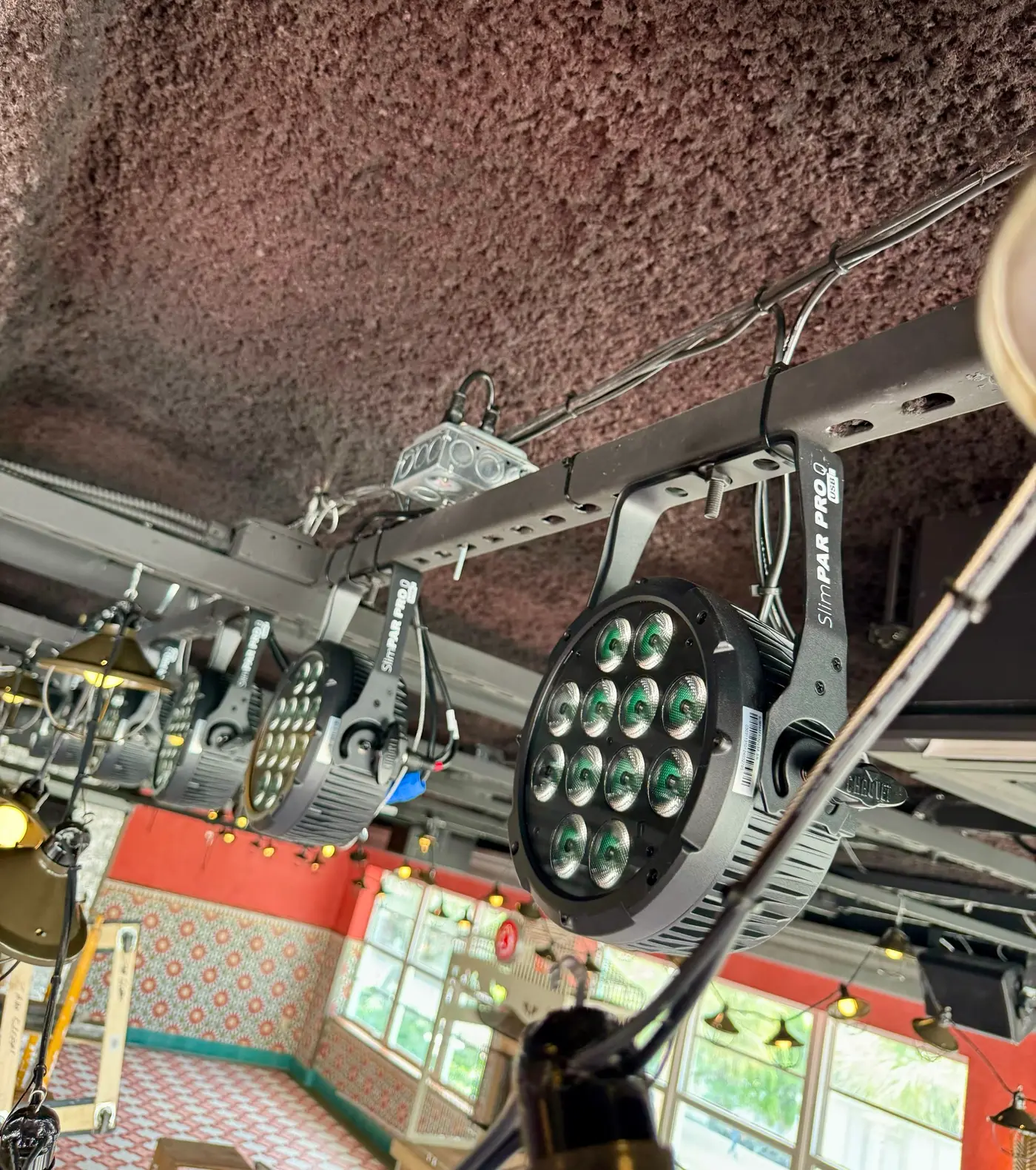 LED stage lighting fixtures on a ceiling rig