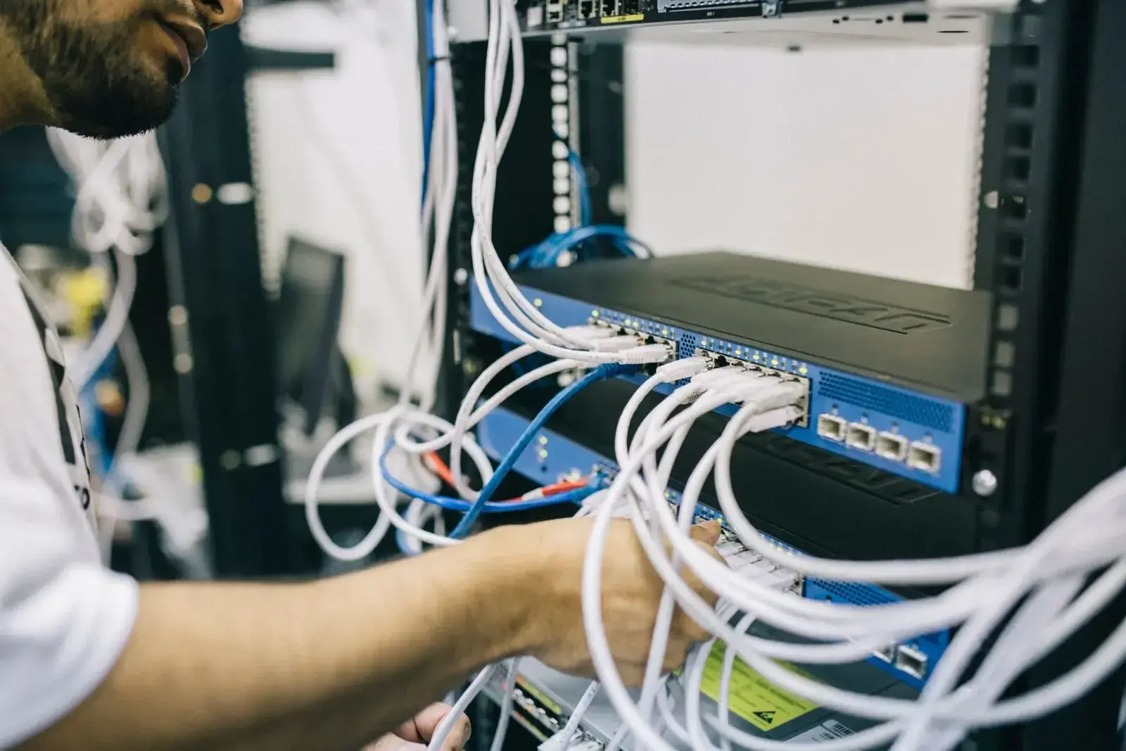 DIST technician patching a network and recording rack