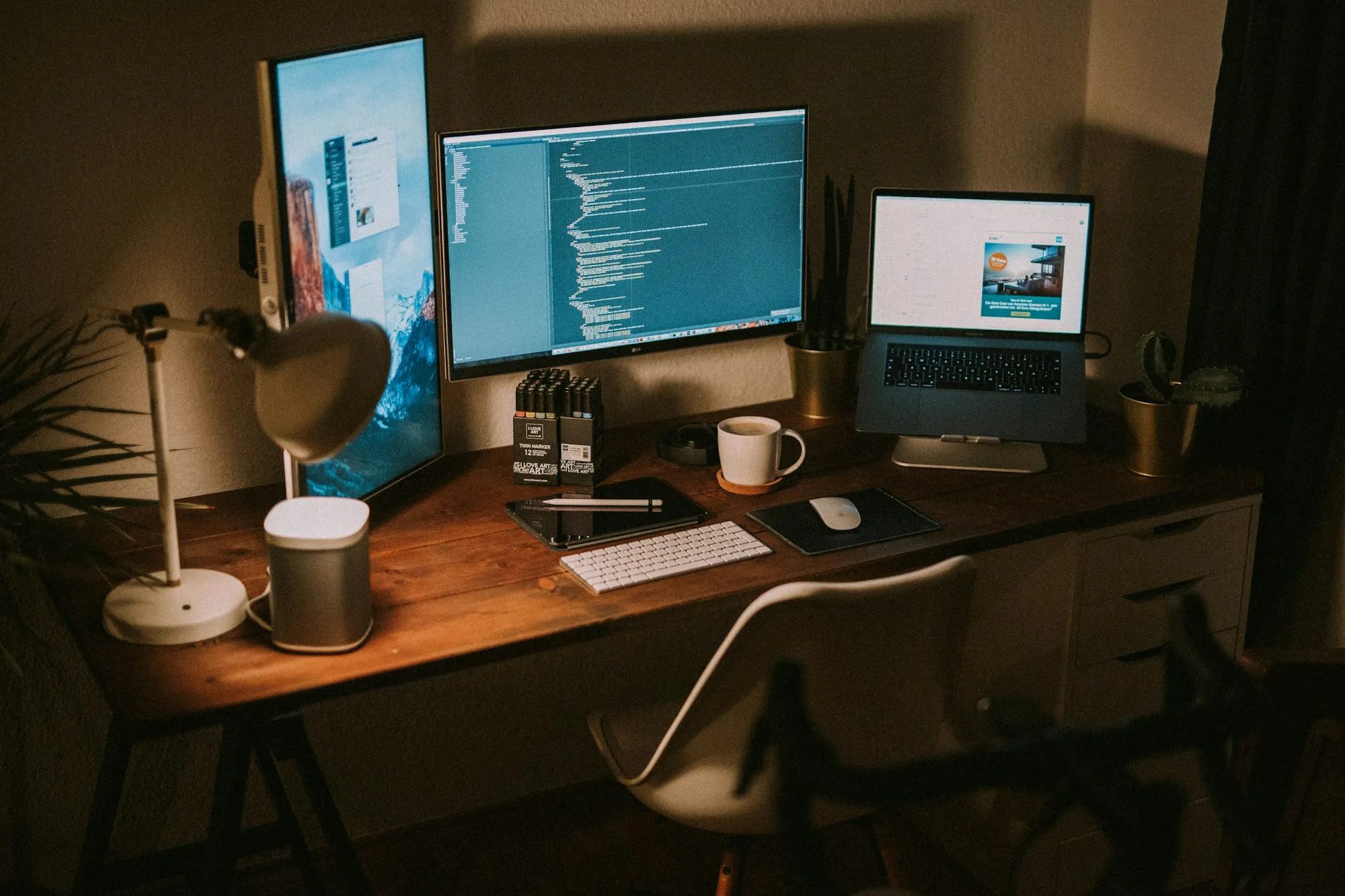 Office workstation with dual monitors and a laptop